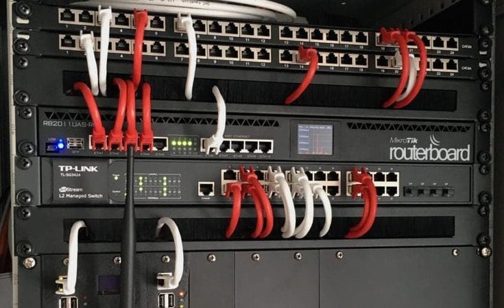 MikroTik RouterBOARD and TP-Link switch in a network rack